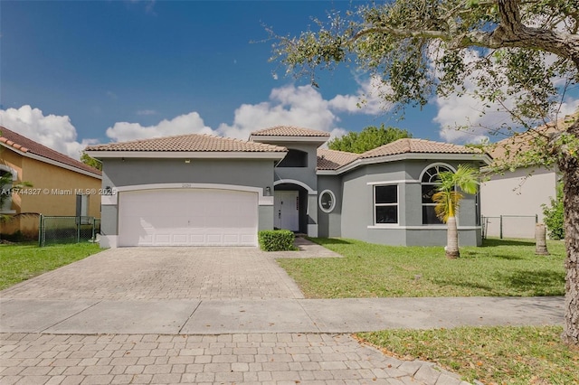 2120 SE 17th Ave, Homestead, FL 33035 - mediterranean / spanish-style house with stucco siding, decorative driveway, a tile roof, and an attached garage