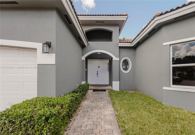 entrance to property with a lawn