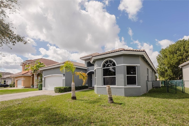 mediterranean / spanish-style home with a front yard, a garage, and central air condition unit