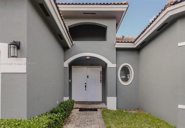 2120 SE 17th Ave, Homestead, FL 33035 - property entrance with stucco siding and a tiled roof