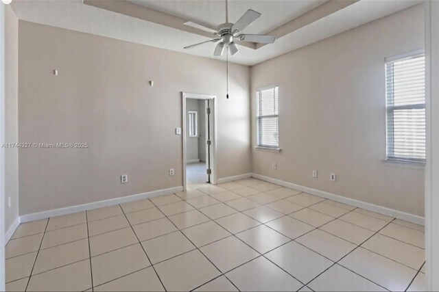 2120 SE 17th Ave, Homestead, FL 33035 - spare room featuring ceiling fan, a tray ceiling, and light tile patterned flooring