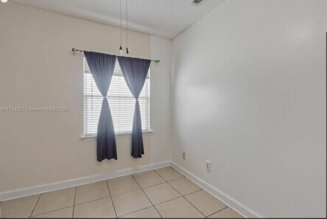 2120 SE 17th Ave, Homestead, FL 33035 - empty room with baseboards and light tile patterned flooring