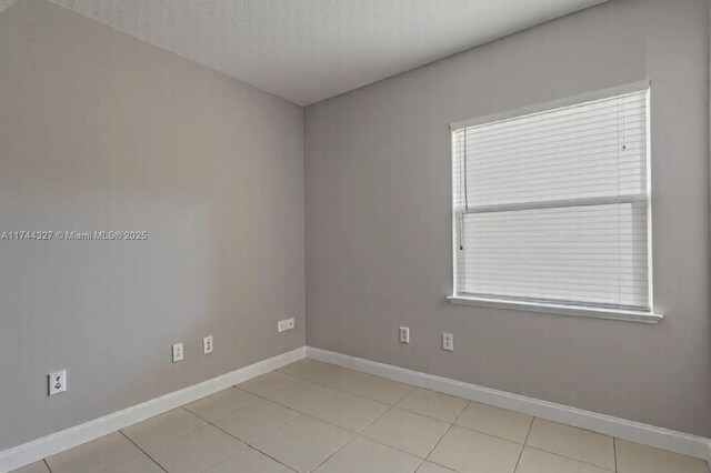 2120 SE 17th Ave, Homestead, FL 33035 - unfurnished room with light tile patterned floors and a textured ceiling