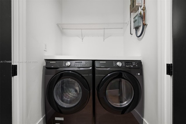 clothes washing area with washing machine and dryer