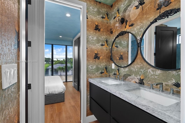 bathroom with a water view, vanity, and hardwood / wood-style floors