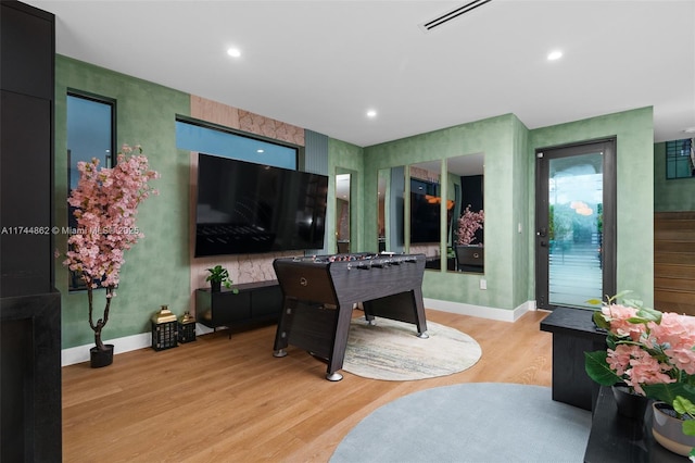 recreation room with light hardwood / wood-style floors