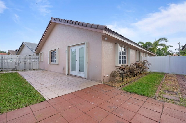 rear view of house featuring french doors and a patio area