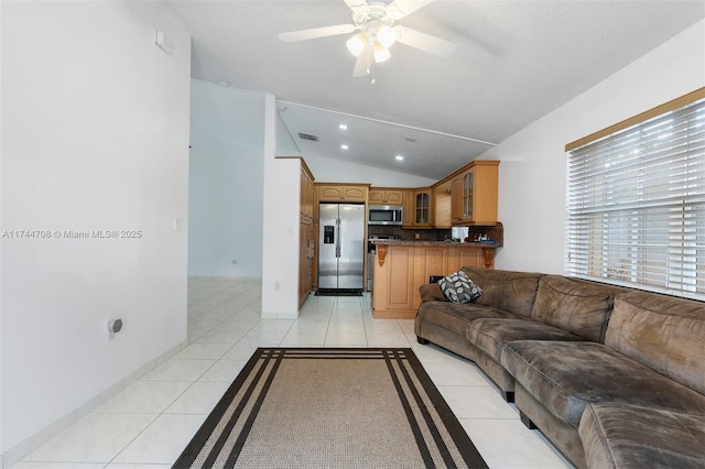 living room featuring light tile patterned flooring, ceiling fan, and vaulted ceiling