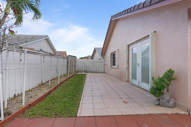 view of yard with a patio area and french doors