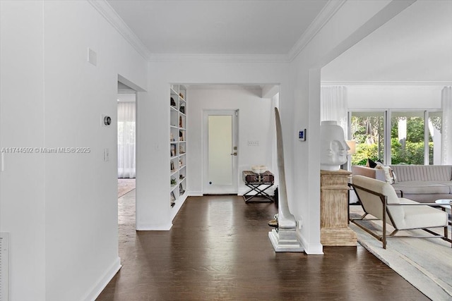 foyer with ornamental molding and dark hardwood / wood-style flooring