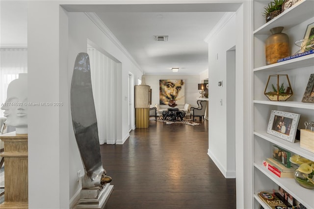 corridor with ornamental molding, dark hardwood / wood-style floors, and built in shelves