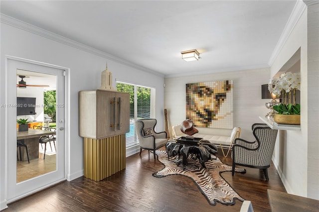 living area featuring crown molding and dark hardwood / wood-style flooring