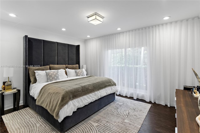 bedroom with dark hardwood / wood-style flooring