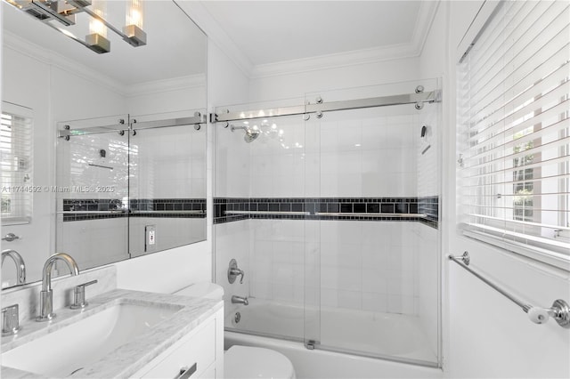 bathroom featuring toilet, ornamental molding, bath / shower combo with glass door, and a wealth of natural light