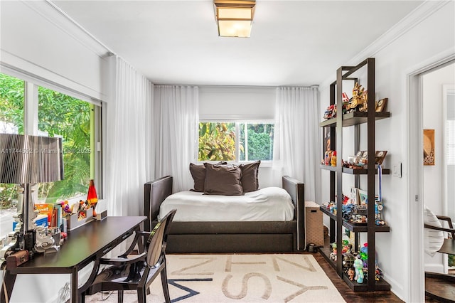 bedroom with hardwood / wood-style flooring and ornamental molding