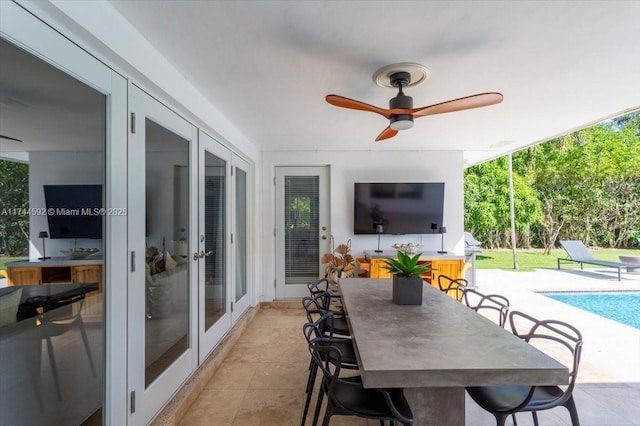 sunroom featuring french doors and ceiling fan