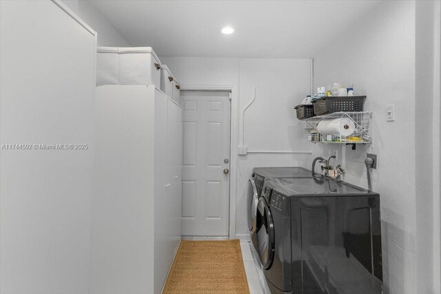 laundry room featuring independent washer and dryer and laundry area