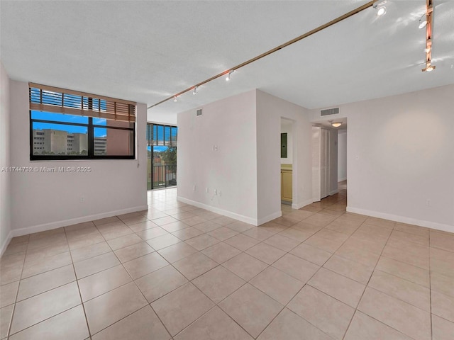 9420 W Flagler St Unit 312, Miami, FL 33174 - unfurnished room with track lighting, light tile patterned flooring, and baseboards