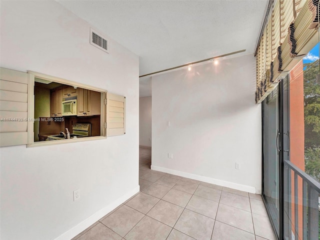 unfurnished room with light tile patterned floors