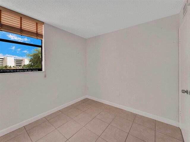 9420 W Flagler St Unit 312, Miami, FL 33174 - unfurnished room with light tile patterned floors, baseboards, and a textured ceiling