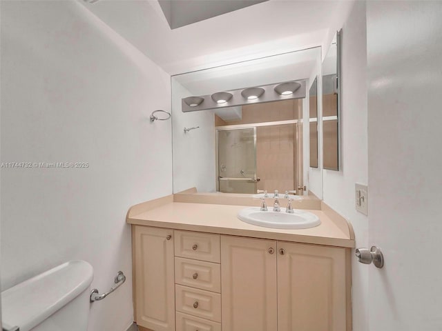 bathroom with vanity, walk in shower, and toilet