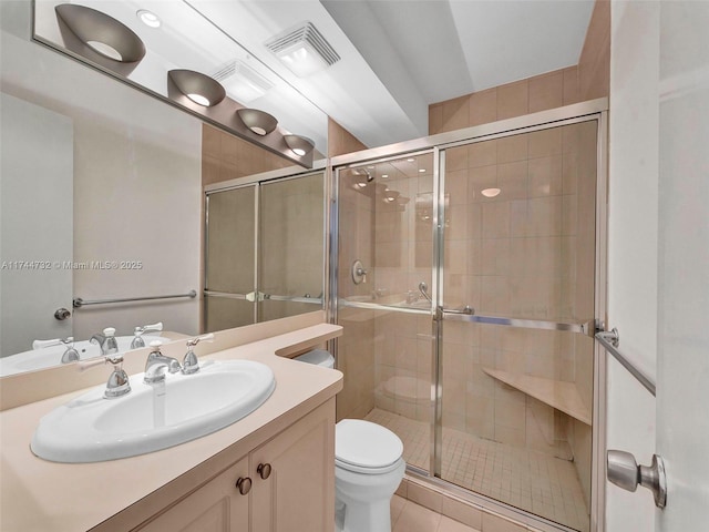 bathroom with an enclosed shower, vanity, tile patterned floors, and toilet