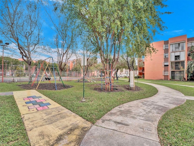 view of home's community featuring a playground and a lawn