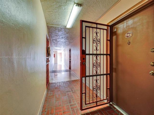 corridor with a textured ceiling