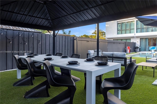 view of patio with a fenced in pool, a gazebo, and an outdoor hangout area