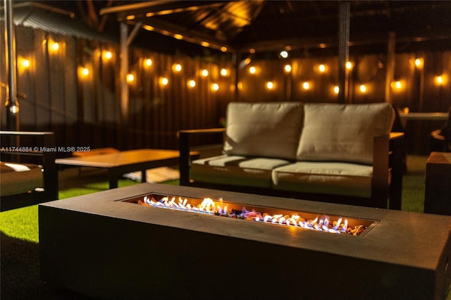 view of patio with an outdoor living space with a fire pit