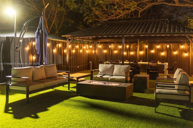 view of patio with a gazebo and an outdoor living space with a fire pit