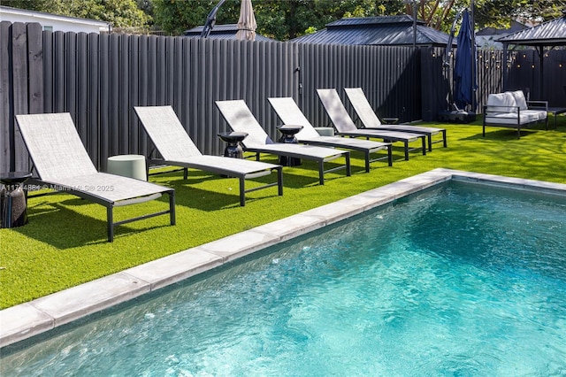 view of swimming pool featuring a gazebo and a yard