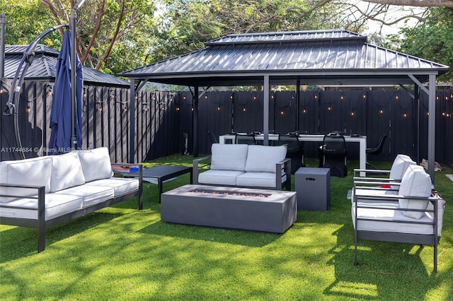 view of patio / terrace featuring a gazebo and an outdoor living space with a fire pit