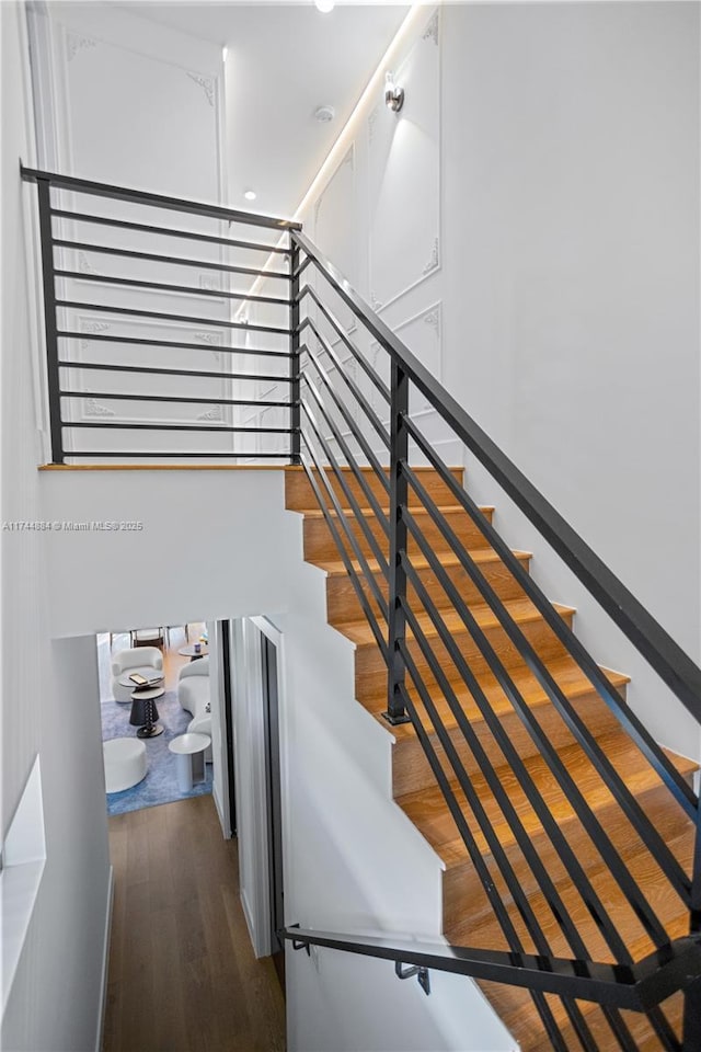 stairs with hardwood / wood-style flooring