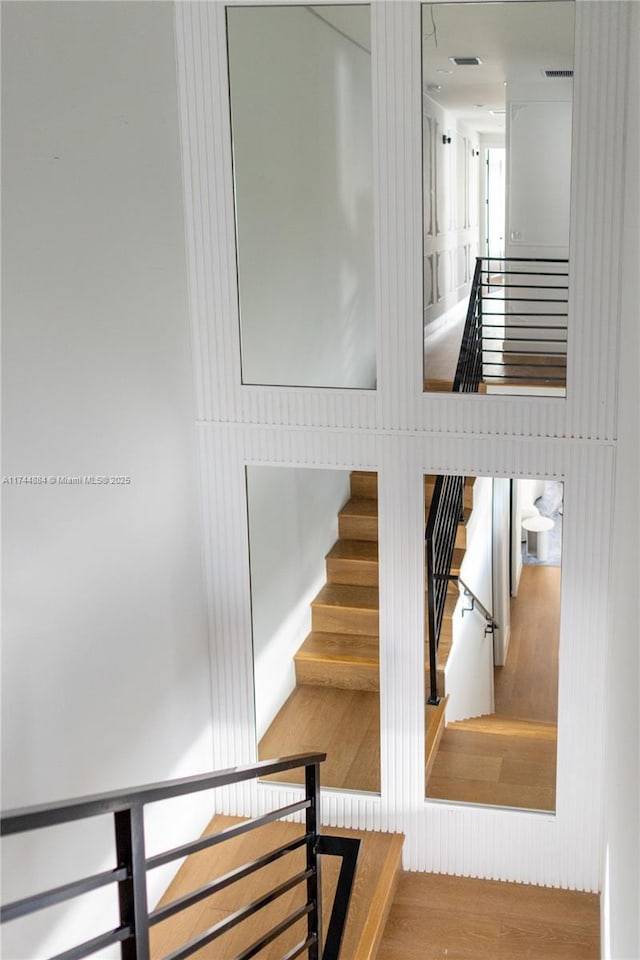 stairs featuring wood-type flooring