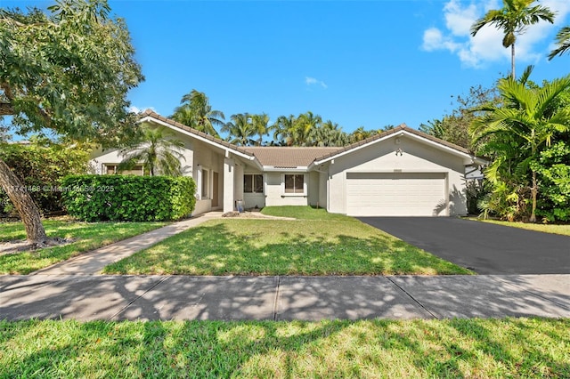 ranch-style home with a garage and a front lawn