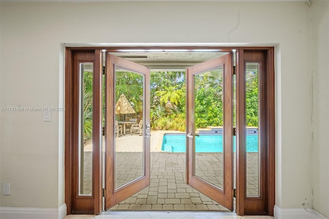 2061 NE 207th St, Miami, FL 33179 - doorway to outside featuring baseboards