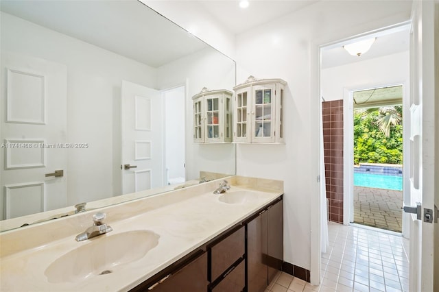2061 NE 207th St, Miami, FL 33179 - bathroom with tile patterned floors, double vanity, and baseboards