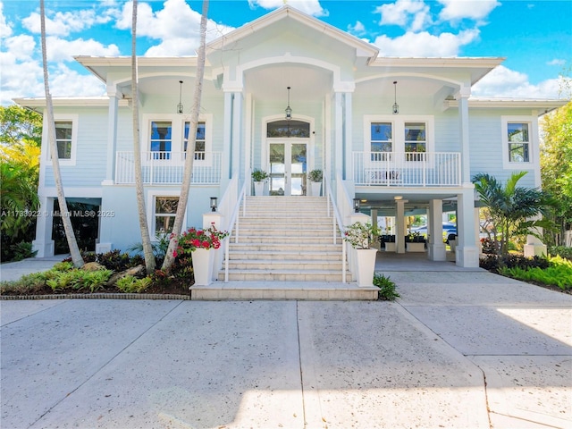 view of front facade with a carport, french doors, and a porch