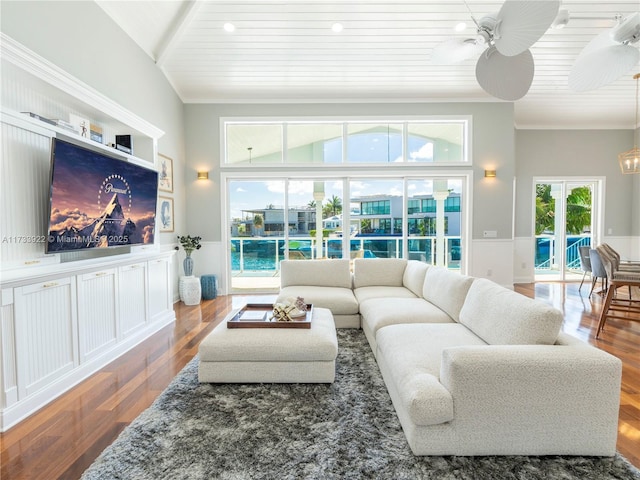 living room featuring hardwood / wood-style flooring, ceiling fan, and ornamental molding