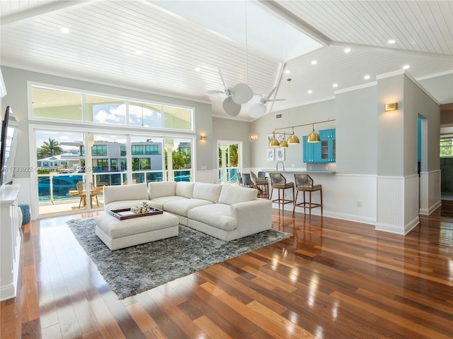 living room with wood ceiling, ornamental molding, high vaulted ceiling, and dark wood-type flooring