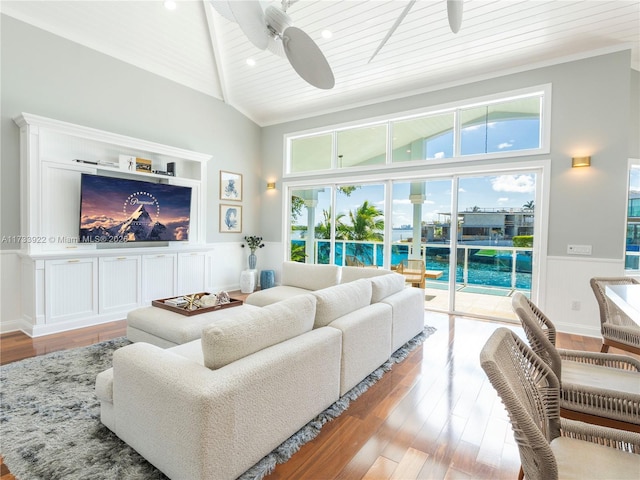 living room with vaulted ceiling, wood ceiling, ceiling fan, and light hardwood / wood-style flooring