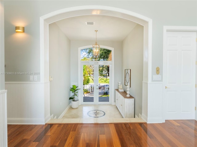 foyer with an inviting chandelier and light hardwood / wood-style floors