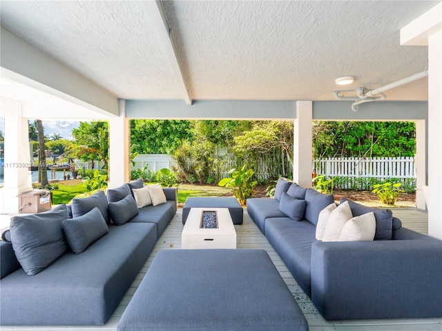 view of patio / terrace with an outdoor living space with a fire pit and ceiling fan