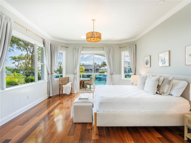 bedroom with hardwood / wood-style floors, crown molding, and access to outside