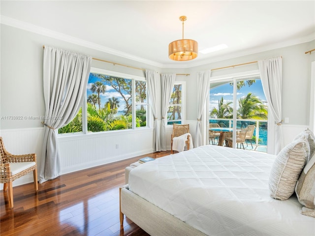 bedroom featuring hardwood / wood-style floors, access to outside, and multiple windows