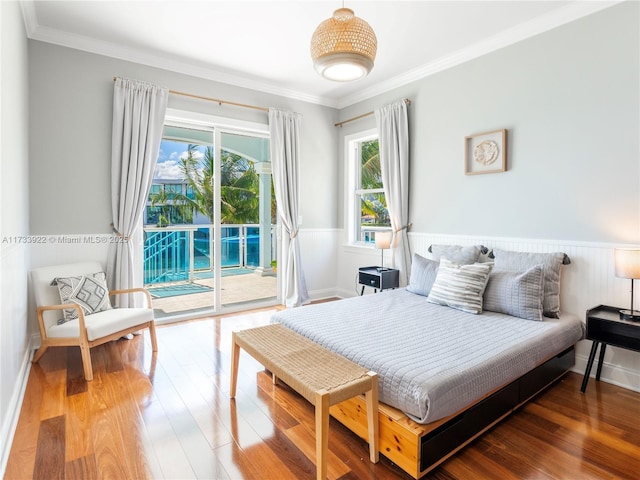 bedroom featuring ornamental molding, access to outside, and hardwood / wood-style floors