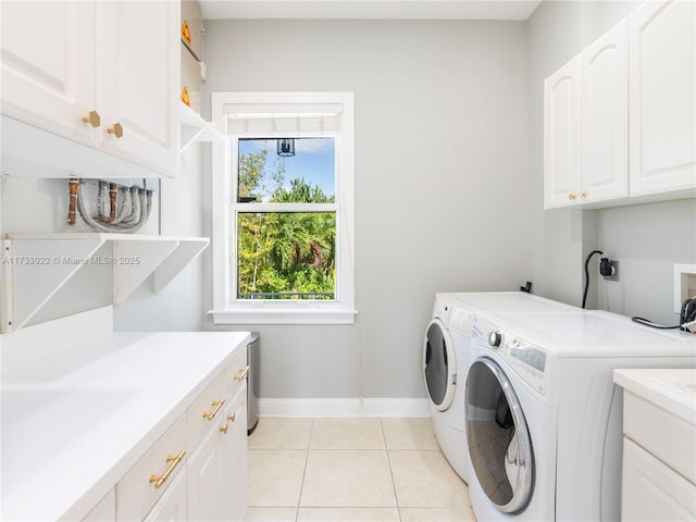 laundry area featuring cabinets, washer and clothes dryer, sink, and light tile patterned floors