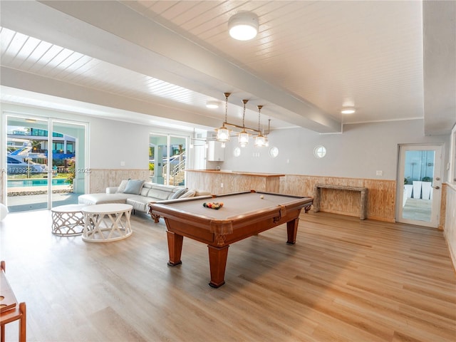 recreation room with beamed ceiling, hardwood / wood-style floors, wood ceiling, and french doors