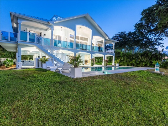 back of house featuring a yard and a patio area